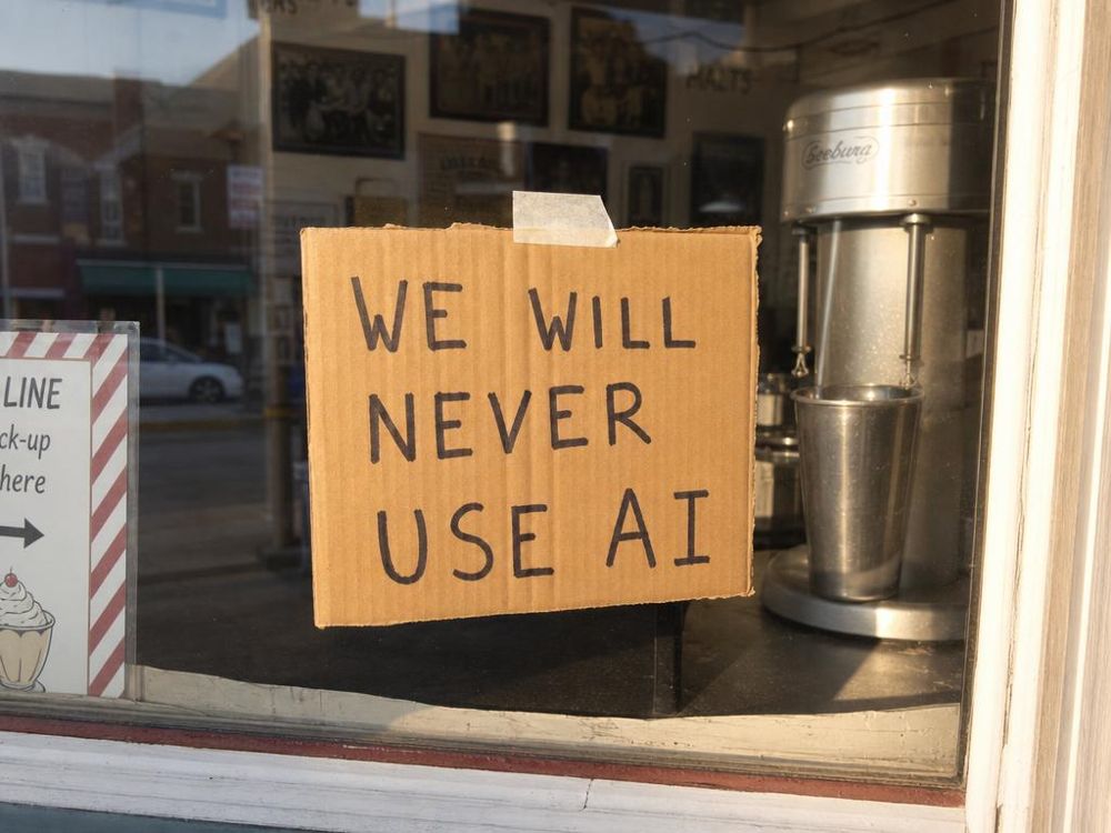 Reenactment, by AI, of a hand-written cardboard sign promising never to use AI